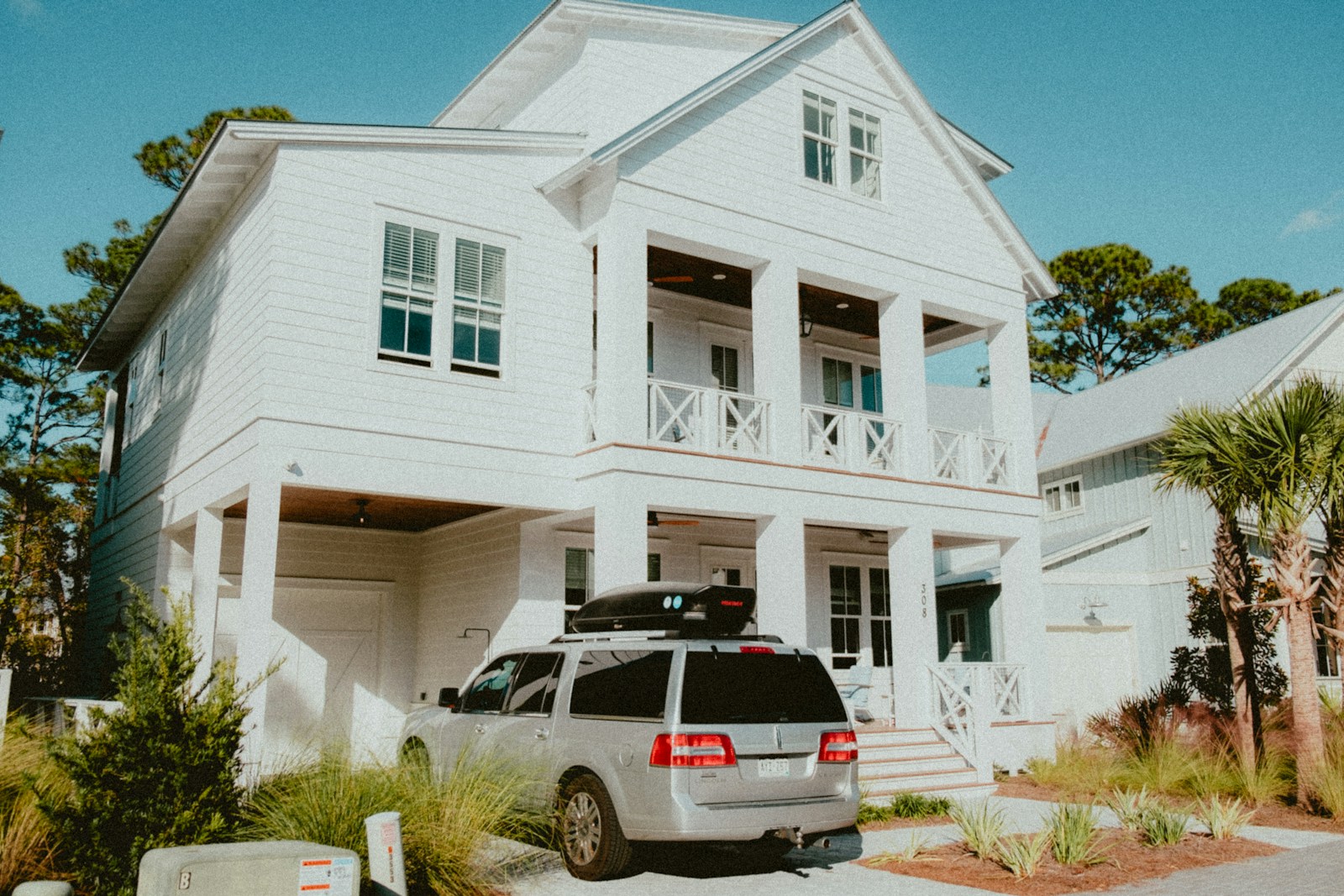 a car parked in front of a white house